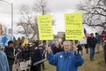 Helena, Montana - April 19, 2020: Senior citizen female protestor holding Bible scripture signs at a prayer rally at the state