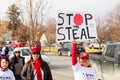 Helena, Montana - Nov 7, 2020: Woman protesting at Stop the Steal rally holding sign, Wearing Trump 2020 gear believing the