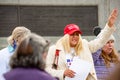 Helena, Montana - Nov 7, 2020: Woman wearing red Make America Great Again hat praying at Stop the Steal rally in support of Donald