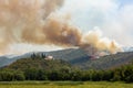 Helicopter against wildfire during strong wind and drought near Miren Castle in Slovenia