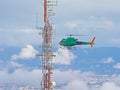 Helicopter approaching a communications antenna Royalty Free Stock Photo