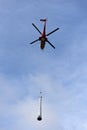 Helicopter as a flying crane transporting a heavy component Royalty Free Stock Photo