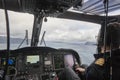 Helicopter cabin with pilot flying over Faroe Islands. Denmark