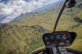 Helicopter cockpit view flying over mountains