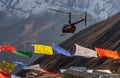 Helicopter and colorful tibetan prayer flags in Annapurna Base Camp, Himalayas Royalty Free Stock Photo