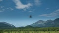 The helicopter descends into the valley.