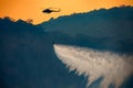 Helicopter dumping water on forest fire Royalty Free Stock Photo