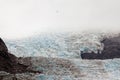 Helicopter dwarfed by nassive glacier ice flow