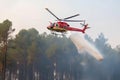 helicopter extinguishes forest fire