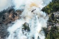 Helicopter extinguishes forest fire on the slope of fuming mount