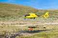 Helicopter firefighters picking up water from small river