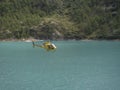 Helicopter flies over the artificial lake of `Place moulin` in Val D`Aosta