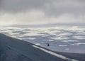 Helicopter flying above Langjokull glacier: contrasts of white snow and black rock mountains. West Iceland, Europe