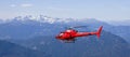 Helicopter flying above mountains