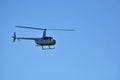 Helicopter flying against the blue sky Royalty Free Stock Photo