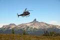 Helicopter flying close to the Black Tusk in Garibaldi Provincial Park, British Columbia