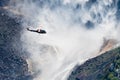 Helicopter flying close to the drop point of Upper Yosemite Falls, Yosemite National Park, California Royalty Free Stock Photo