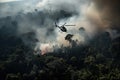helicopter flying low over jungle, with thick smoke billowing from below Royalty Free Stock Photo