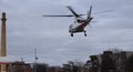 Helicopter Flying Low To The Ground Near Smokestack Royalty Free Stock Photo