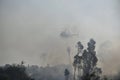 Helicopter drops water on forest fire Royalty Free Stock Photo