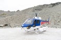 Helicopter from The Helicopter Line Company landing on snowcapped mountain peak around Aoraki Mount Cook and Mount Cook National Royalty Free Stock Photo