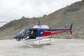 Helicopter from The Helicopter Line Company landing on snowcapped mountain peak around Aoraki Mount Cook and Mount Cook National Royalty Free Stock Photo