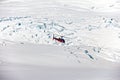 Helicopter hovering over a glacier field of the Franz Josef glacier in New Zealand.