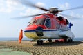 The helicopter landing officer take care loading baggage to helicopter at oil rig Royalty Free Stock Photo