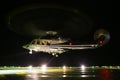 Helicopter landing in offshore oil and gas platform on deck or parking area. Helicopter night flight training of pilot Royalty Free Stock Photo