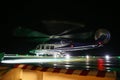 Helicopter landing in offshore oil and gas platform on deck or parking area. Helicopter night flight training of pilot