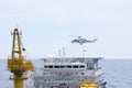 Helicopter landing on offshore oil rig, Passenger transfer to offshore oil and gas platform for work. Royalty Free Stock Photo