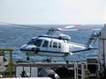 Helicopter landing or taking off from seismic survey vessel