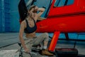 Helicopter maintenance femail worker. woman pilot or helicopter mechanic holding the adjustable wrench.