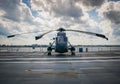 Helicopter parked in the airport against a cloudy sky on a gloomy day