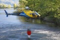 Helicopter picking up water during fire fighting operations