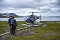 Helicopter Pilot and Crew on the helipad waiting on Passengers