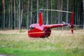 Helicopter Robinson R44 in a meadow near Nida airoport.