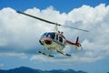 Helicopter on scenic flight with clouds and blue sky Royalty Free Stock Photo