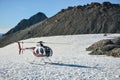 Helicopter of sightseeings flight company on snow field in Southern Alps near Mount Cook in New Zealand