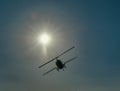 A helicopter silhouetted by the sun.