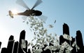 Helicopter in sky dropping money over city Royalty Free Stock Photo