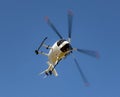 Helicopter soaring in clear blue sky. Royalty Free Stock Photo