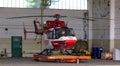 Helicopter standing in hangar on a platform