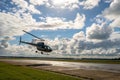 Helicopter taking off under a beautiful cloudy sky Royalty Free Stock Photo