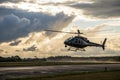 Helicopter taking off under a beautiful cloudy sky Royalty Free Stock Photo