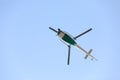 Helicopter with video surveillance system flying in blue sky.