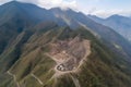 helicopter view of landslide disaster zone, with rescue and cleanup efforts underway