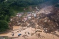 helicopter view of landslide disaster zone, with rescue and cleanup efforts underway