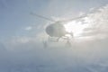 Heliski helicopter takes off in snow powder freeride landed on mountain Royalty Free Stock Photo