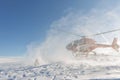 Heliski helicopter takes off in snow powder freeride landed on mountain Royalty Free Stock Photo